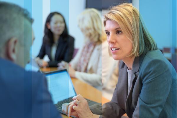 Cubiks Head of Marketing in discussion during business meeting around table